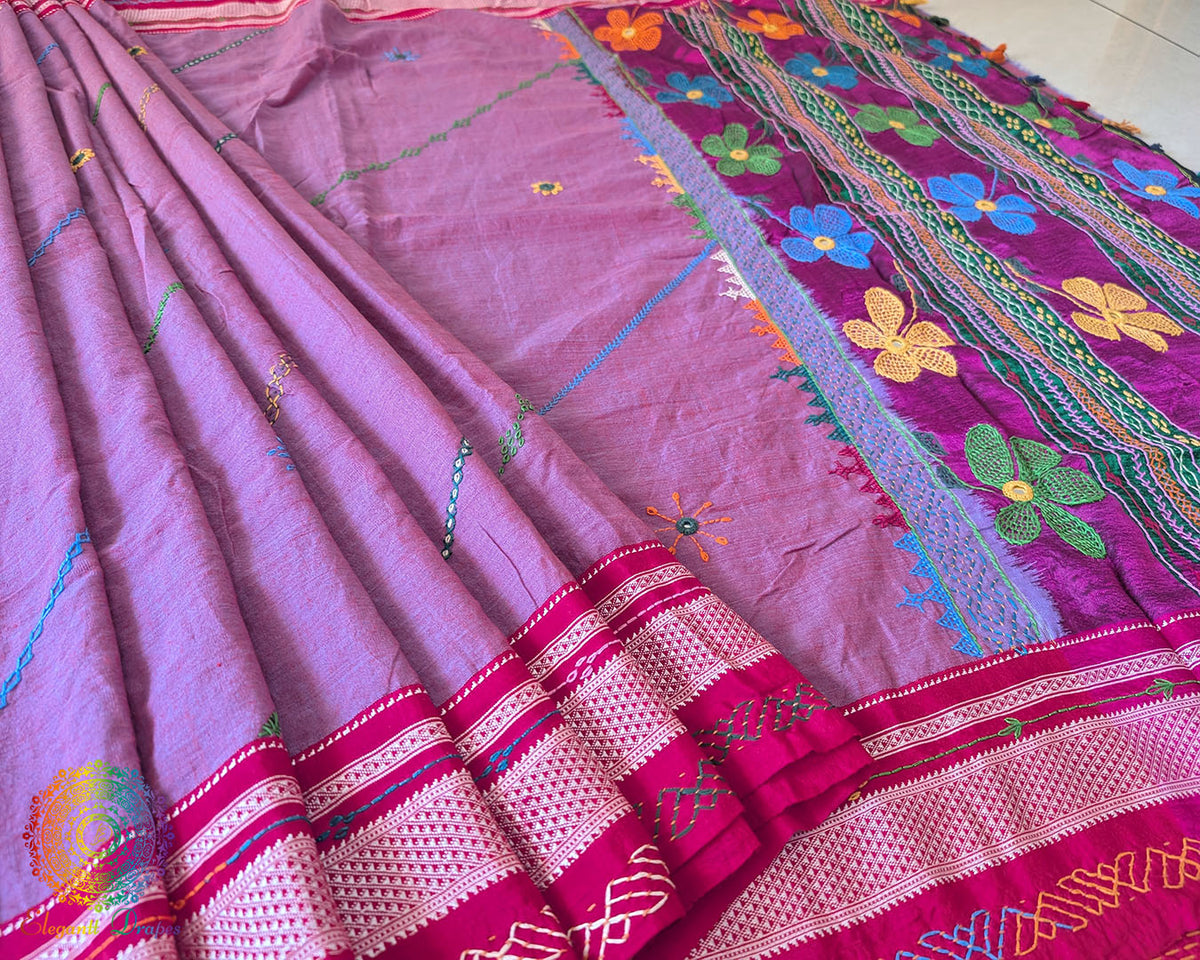 Close-up of Lambani embroidered bels and floral motifs on the mauve cotton saree
