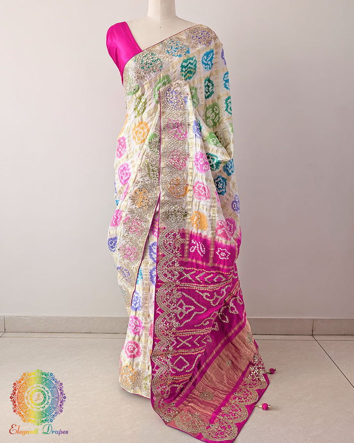 Off-white Pure Gajji Silk Gharchola saree with multicolour Bandhani patterns and Gota Patti handwork, shown in a complete draped view.