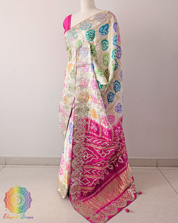 Side drape view of the off-white Gaji Silk Gharchola saree, highlighting its colourful Bandhani design and traditional Gota Patti work.
