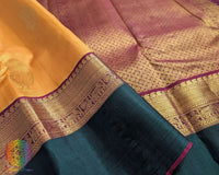Close-up of Mustard handwoven Kanjivaram silk saree green border with 2 gram zari