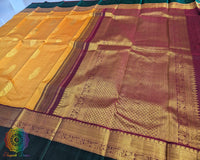 Mustard Kanjivaram silk saree pallu view with green border and zari work