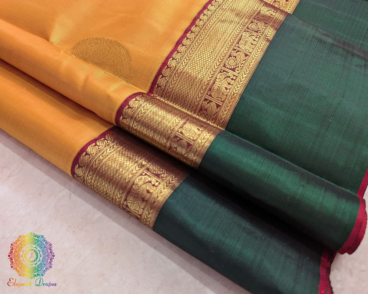 Close up of mustard Kanjivaram silk saree showing pure silk weave and zari detail