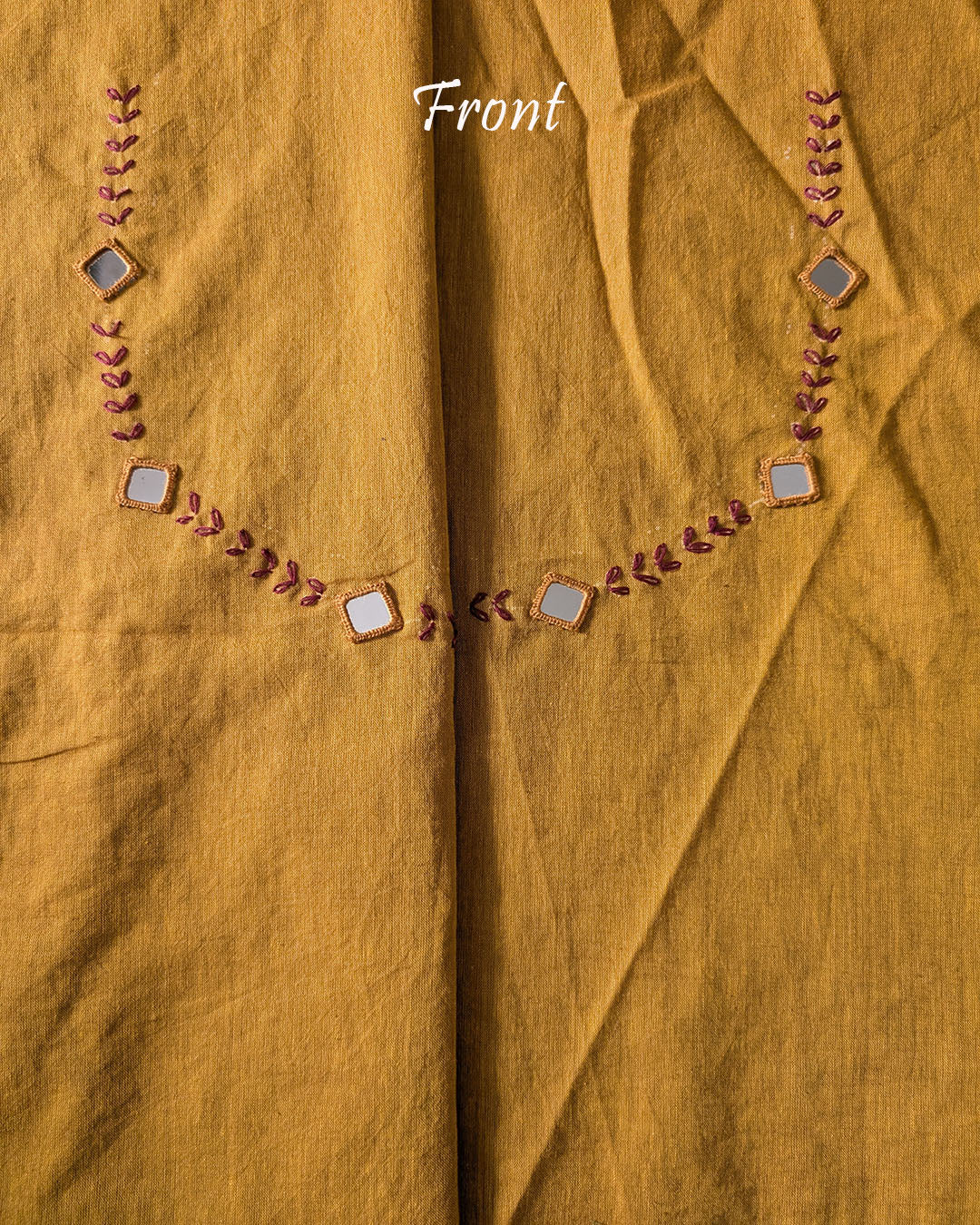 Front neck of the Mustard Kala Cotton Kutch Mirror Handwork blouse piece, showcasing detailed Kutch embroidery and real mirrors arranged in a decorative handcrafted design.