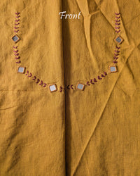 Front neck of the Mustard Kala Cotton Kutch Mirror Handwork blouse piece, showcasing detailed Kutch embroidery and real mirrors arranged in a decorative handcrafted design.