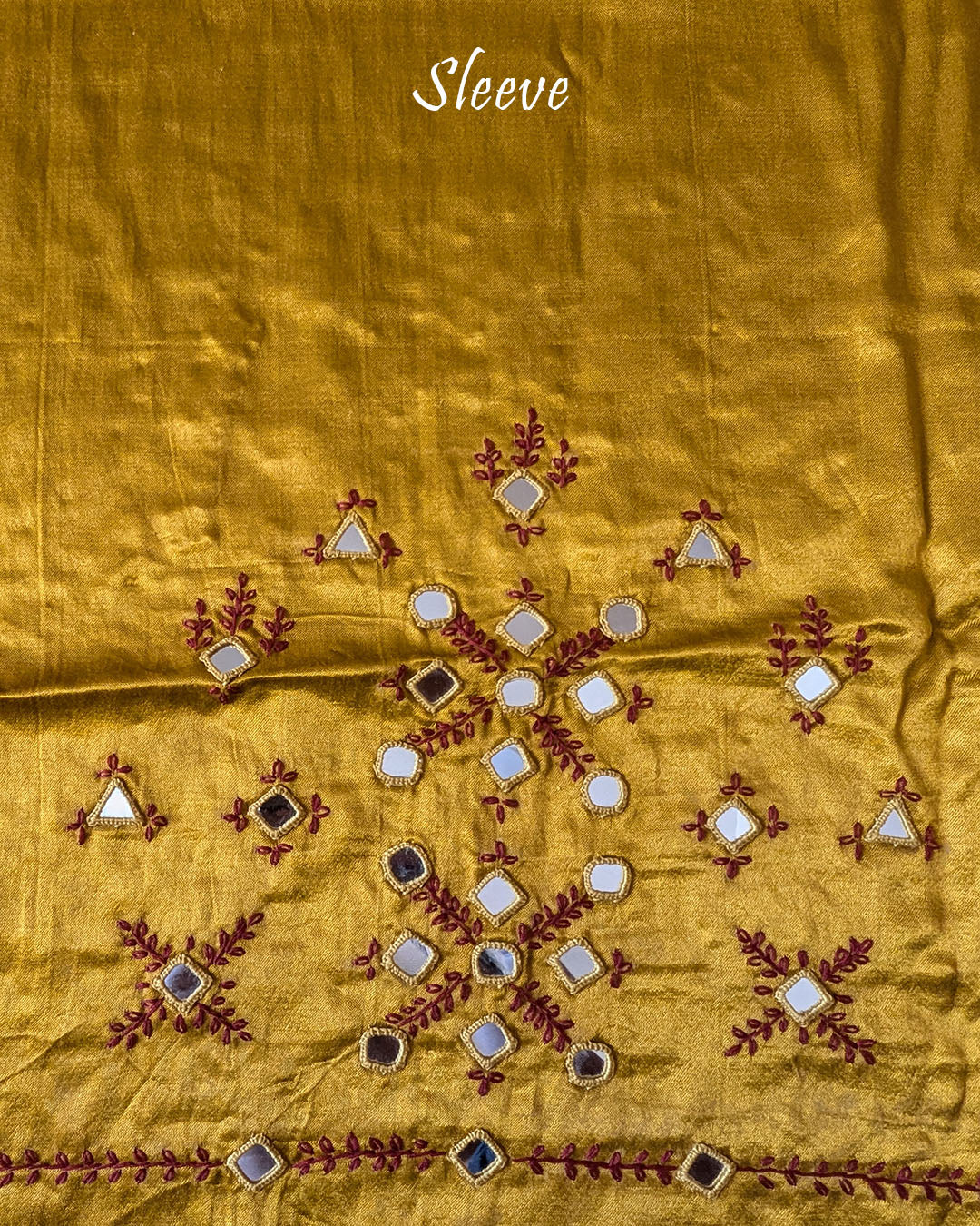 Close-up of Kutch mirror embroidery on sleeve of Mustard Mashru Silk Blouse Piece