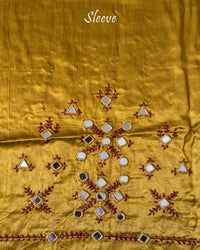 Close-up of Kutch mirror embroidery on sleeve of Mustard Mashru Silk Blouse Piece