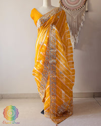Mustard Orange Organza Leheria Saree with Kachha Gota Handwork – Front Drape showcasing the vibrant mustard orange shade, graceful Leheria pattern and intricate handcrafted Gota detailing