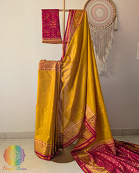Mustard handwoven mulberry silk Rajkot Patola saree on mannequin showing red palla and full drape
