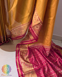 Red palla close up on mustard Rajkot Patola saree highlighting intricate woven motifs