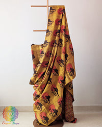 Yellow Nashpal Pomegranate Ajrakh Modal Tussar Silk Saree with the palla fully opened, showcasing its vibrant yellow colour and distinctive striped Ajrakh pattern.