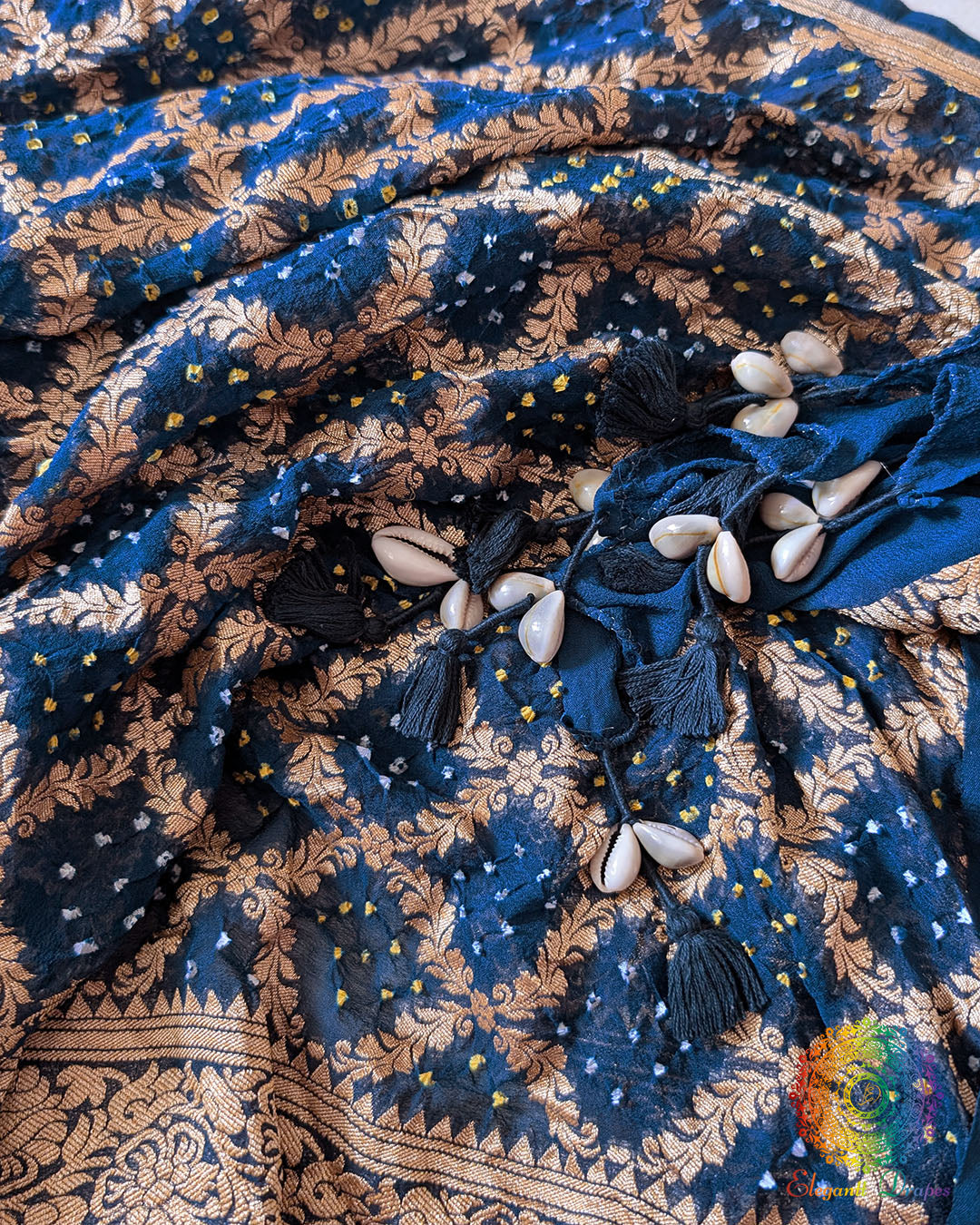 Close-up of traditional kodi tassels, zari border, and Bandhani motifs on navy blue Banarasi georgette Gharchola dupatta