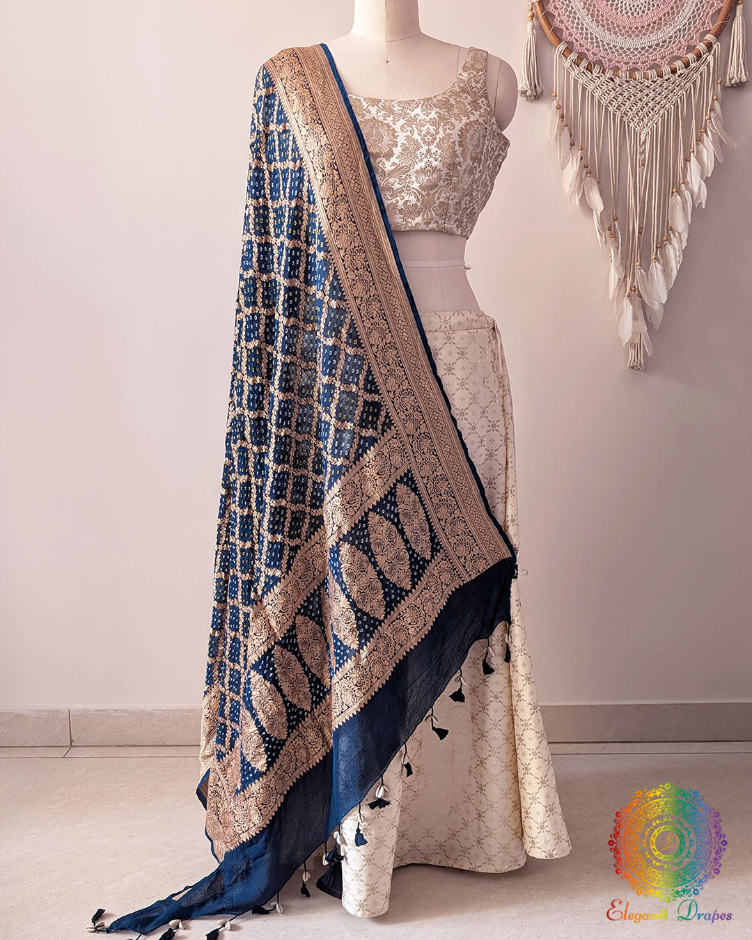 Navy blue Banarasi georgette Gharchola Bandhani dupatta draped on mannequin with zari border and kodi tassels