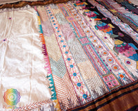 Off white Ilkal silk saree body close up highlighting fabric texture and embroidery