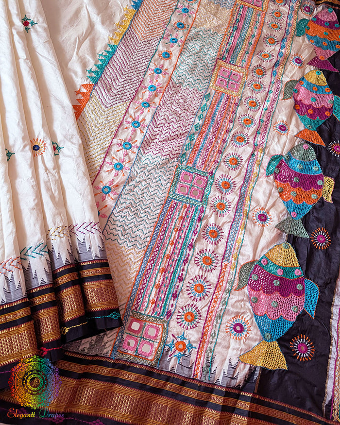 Flat lay view of off white pure Ilkal silk saree with Lambani hand embroidery