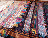 Off white Ilkal silk saree with black palla and border displaying traditional embroidery