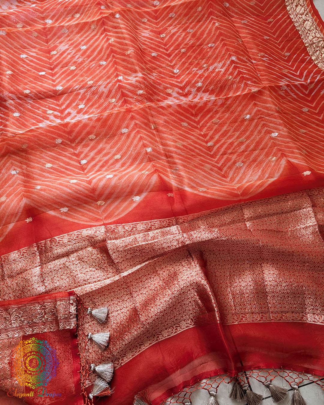 Close-up of Leheriya Pallu detailing on Orange Banarasi Kora Silk Saree
