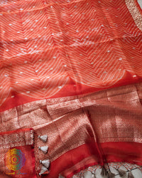 Close-up of Leheriya Pallu detailing on Orange Banarasi Kora Silk Saree