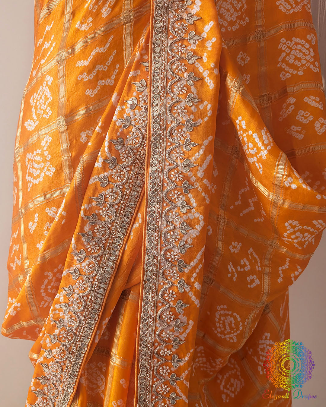 Close up of gota patti work on orange gaji silk Gharchola saree palla