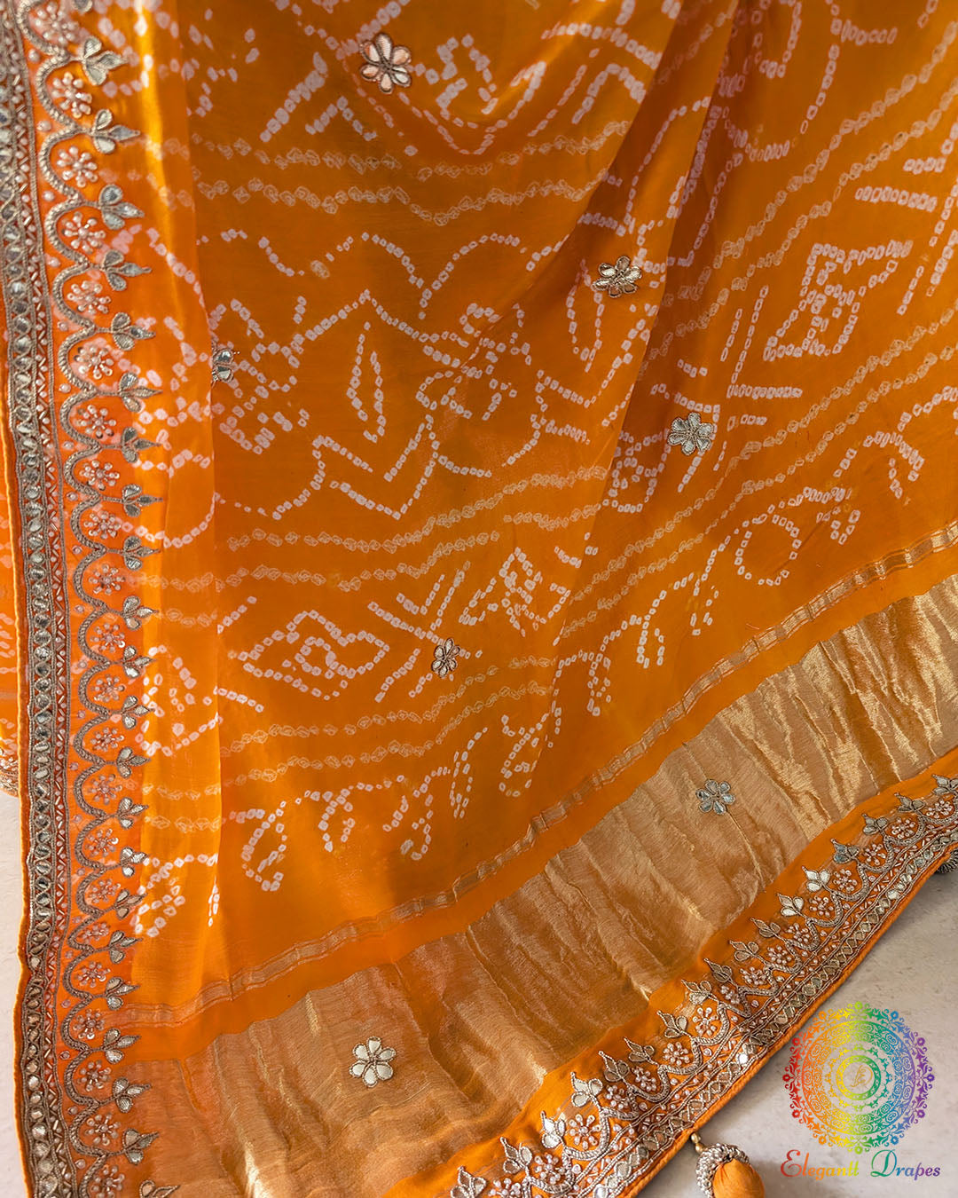 Intricate gota patti work detail on orange gaji silk festive saree