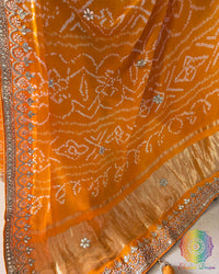 Intricate gota patti work detail on orange gaji silk festive saree