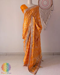 Orange gaji silk Gharchola saree on mannequin showing full drape and gota patti work