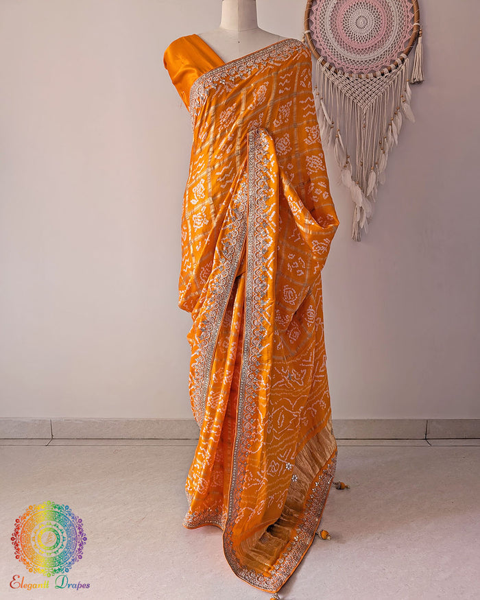 Orange gaji silk Gharchola saree on mannequin showing full drape and gota patti work