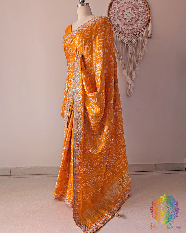 Side angle view of orange Gharchola saree highlighting gota patti palla detailing