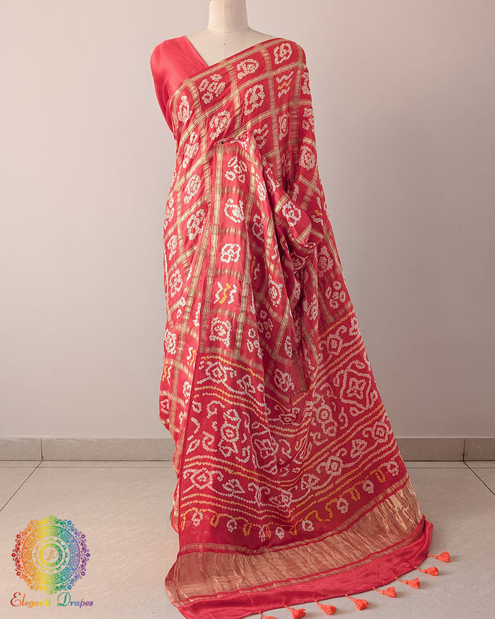 Orange Pure Gaji Silk Bandhani Gharchola Saree with the palla visible in a draped view, displaying the Gharchola pattern and traditional Bandhani detailing.