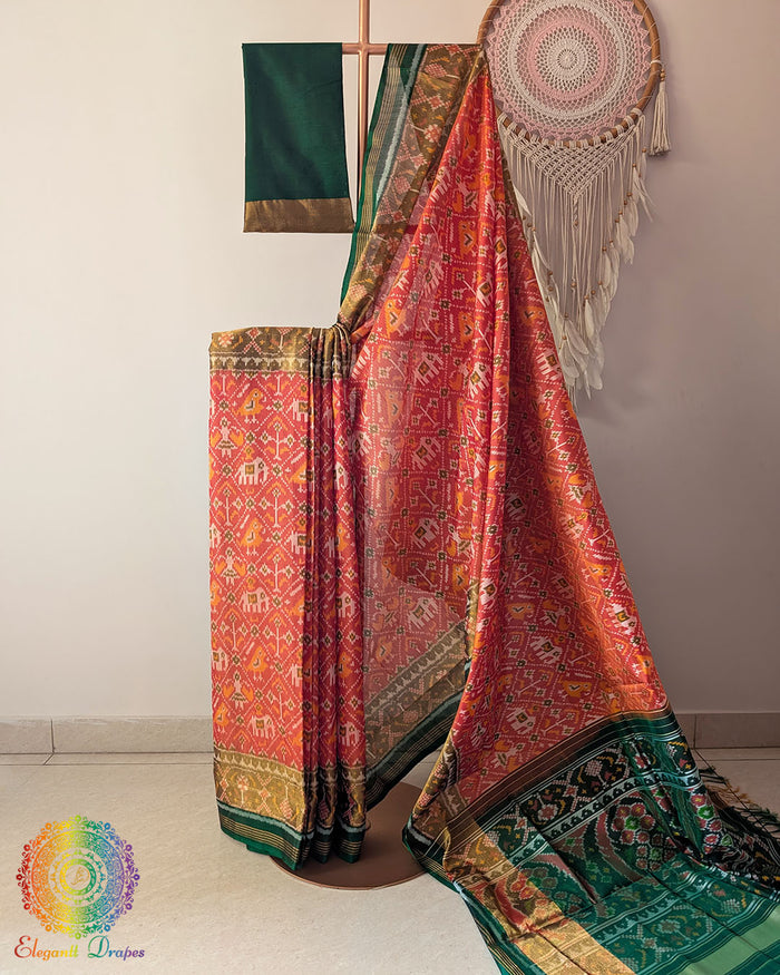 Orange handwoven mulberry silk Rajkot Patola saree on mannequin showing full drape