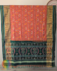 Open palla view of orange Rajkot Patola pure mulberry silk saree displaying woven design
