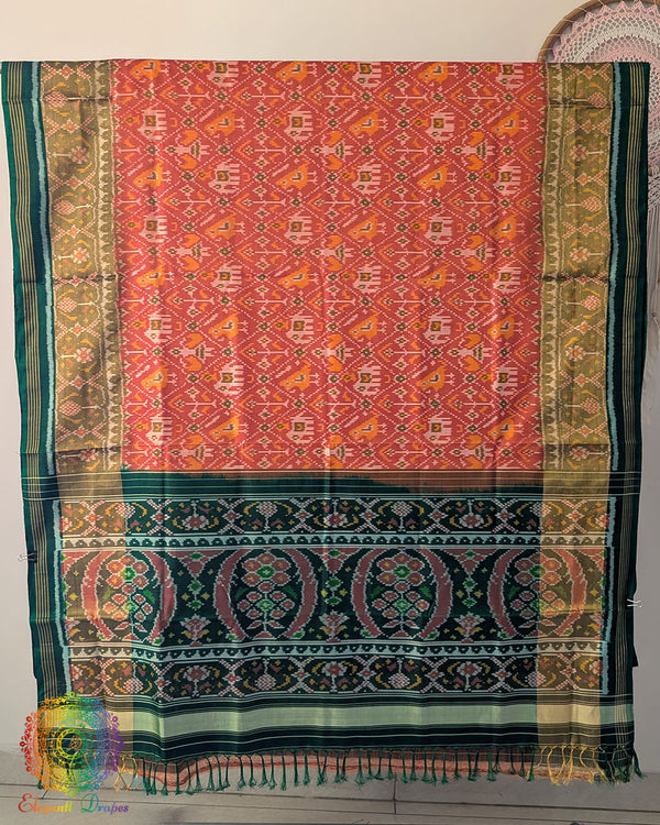 Open palla view of orange Rajkot Patola pure mulberry silk saree displaying woven design