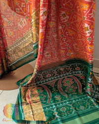 Orange Rajkot Patola saree palla close up highlighting intricate woven motifs