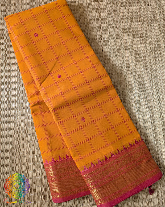 Folded orange pure Kanchi cotton checkered saree showing woven checks pattern