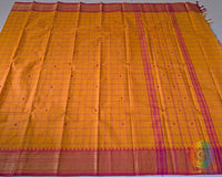 Full orange Kanchi cotton checkered saree laid open showcasing overall design and drape