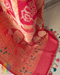 Palla close up on orange peach georgette saree highlighting meenakari bandhani work