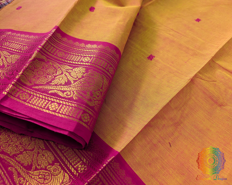 Pink border close up on orange Kanchi cotton saree highlighting weave detail
