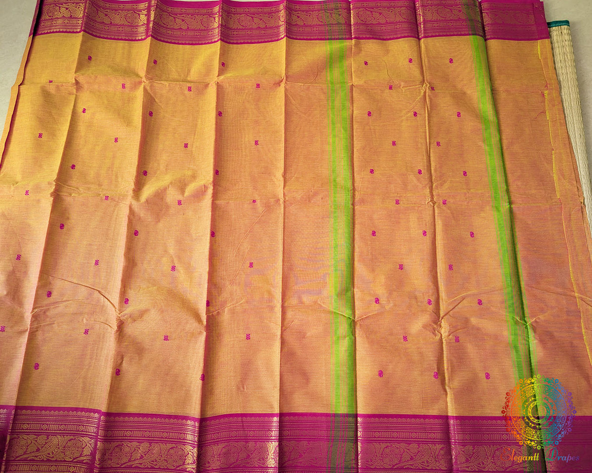 Full orange Kanchi cotton saree laid flat showing contrast pink border and design