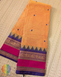 Orange Kanchi cotton saree folded view showing vibrant color and texture