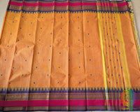 Full orange Kanchi cotton saree laid flat showing complete design and drape