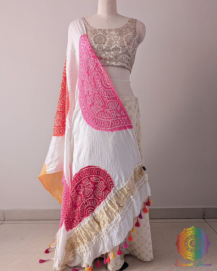 White Gajji Silk Orange Pink Red Yellow Bandhani Dupatta in a full draped view, showcasing the white base decorated with vibrant orange, pink, red and yellow traditional Bandhani motifs.