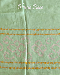 Matching blouse piece in pastel green Gharchola bandhani silk showing fabric