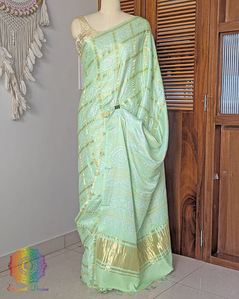 Pastel green gaji silk saree on mannequin showcasing Gharchola pattern