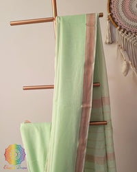 Pastel green Bengal cotton saree body close up highlighting fabric texture with zari border detail