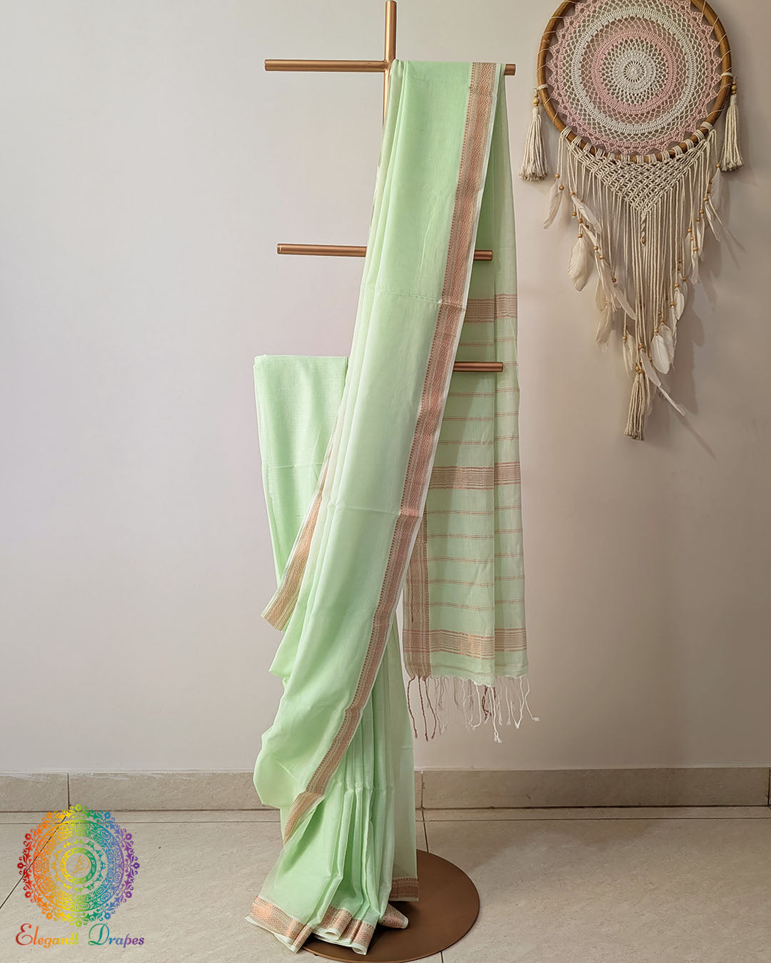 Pastel green Bengal cotton saree with zari border on mannequin showing full drape