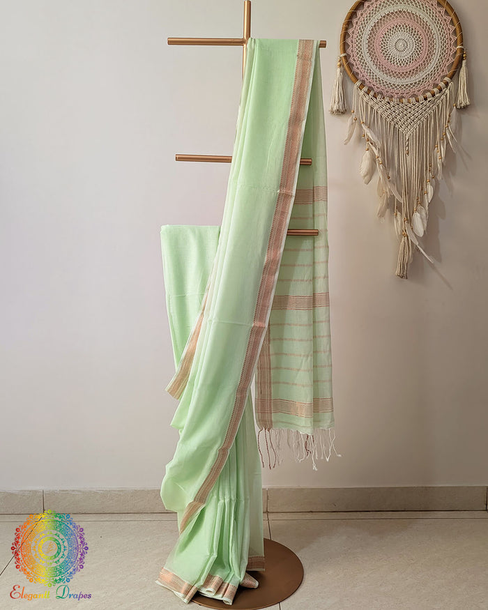 Pastel green Bengal cotton saree with zari border on mannequin showing full drape