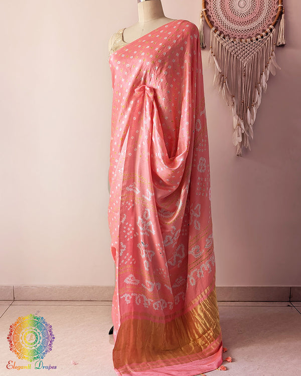 Side angle view of pastel peach bandhani saree highlighting fluid silk drape