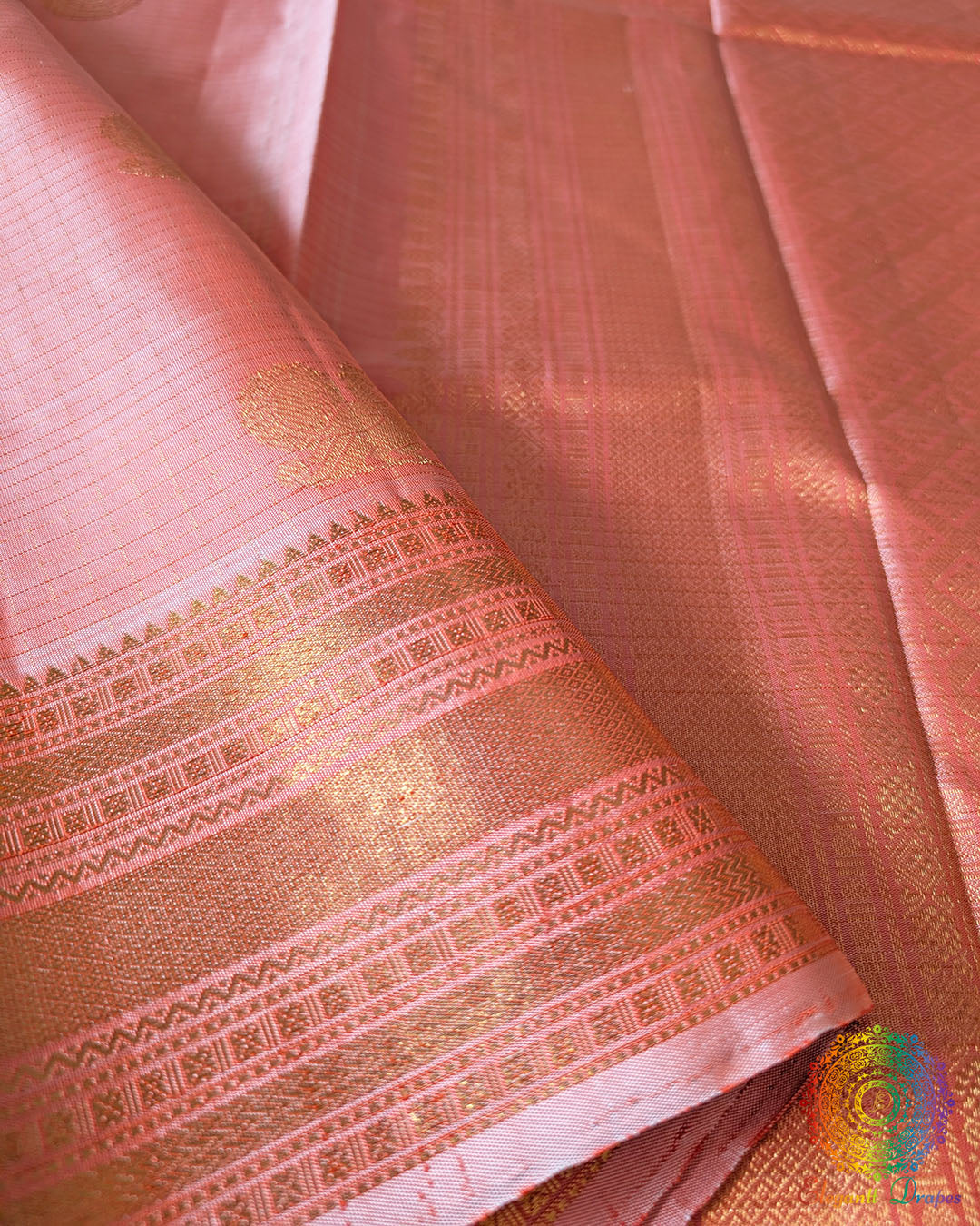 Close-up of the rich silk weave and authentic 2-Gram Gold Zari on the Pastel Peach Pure Kanjivaram Silk Saree