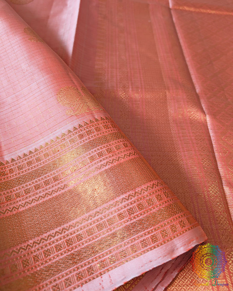 Close-up of the rich silk weave and authentic 2-Gram Gold Zari on the Pastel Peach Pure Kanjivaram Silk Saree
