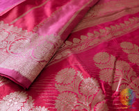 Border close up on pink shaded red Banarasi silk saree highlighting woven detail