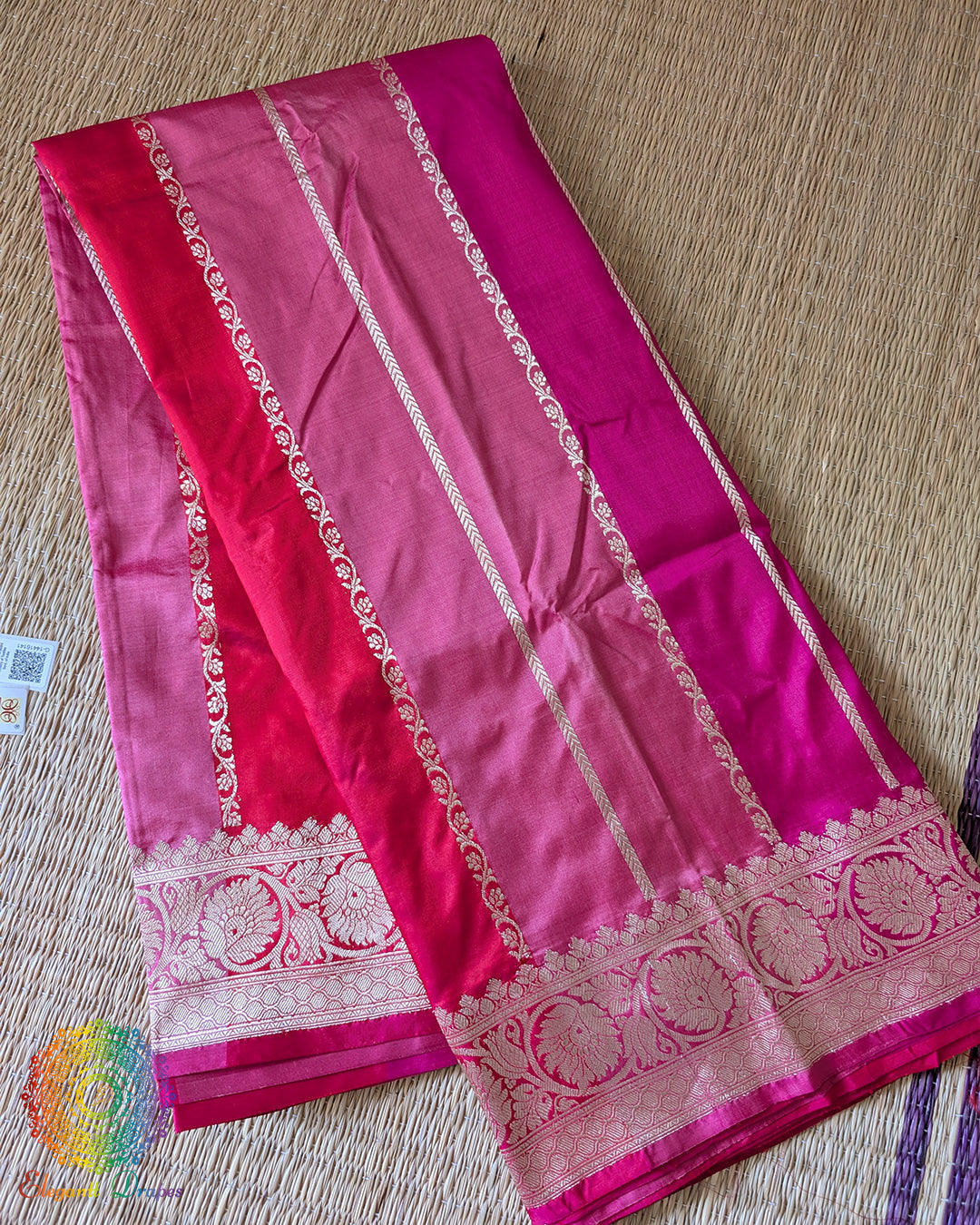 Folded pink shaded red Banarasi handloom Katan silk saree showing woven texture